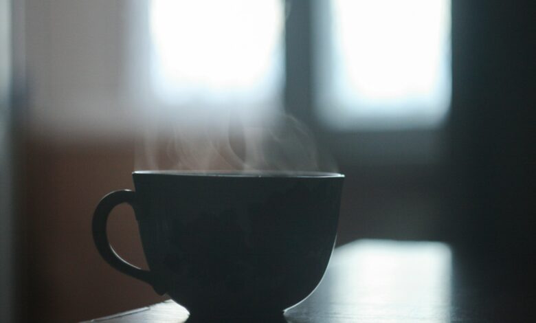black ceramic teacup on table